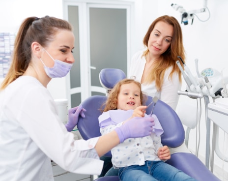 dentistry_thirty_two_children_dentistry_girl_with_her_mom_and_dentist